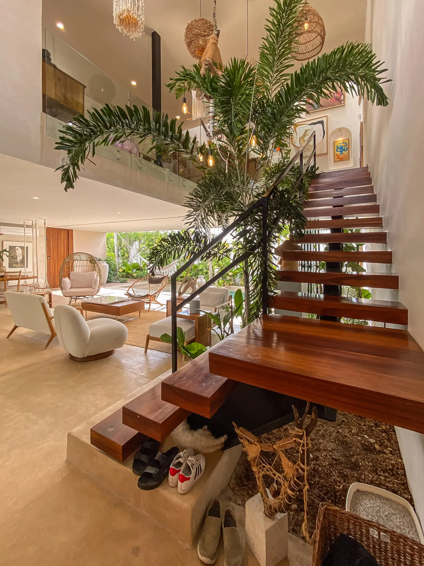 Floating wood staircase detail against a double-height interior, the kind of finish-quality shot international buyers look for