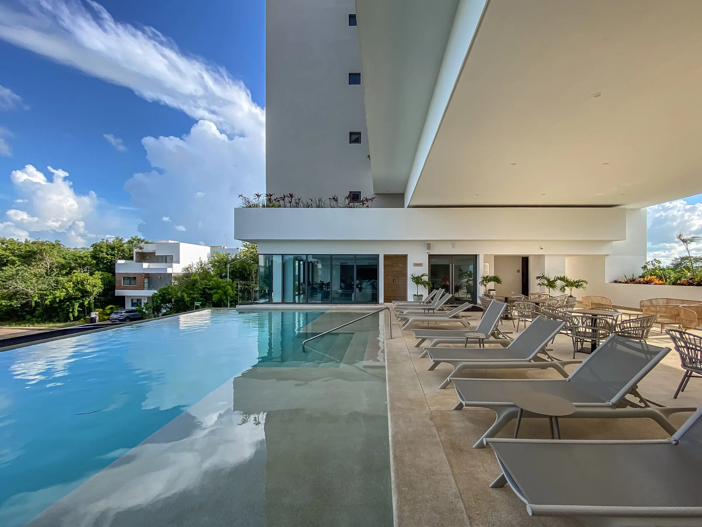 Pool deck with lounge chairs at golden hour, the single strongest identity photo for this vacation rental listing