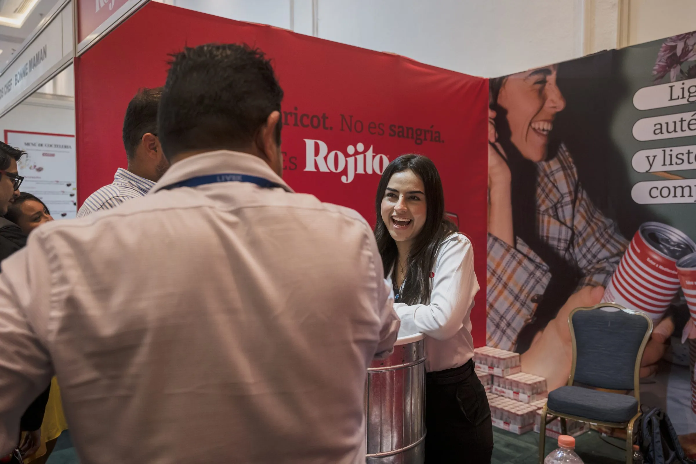 Sponsor booth branding on full display as a staff member engages with an attendee at the stand