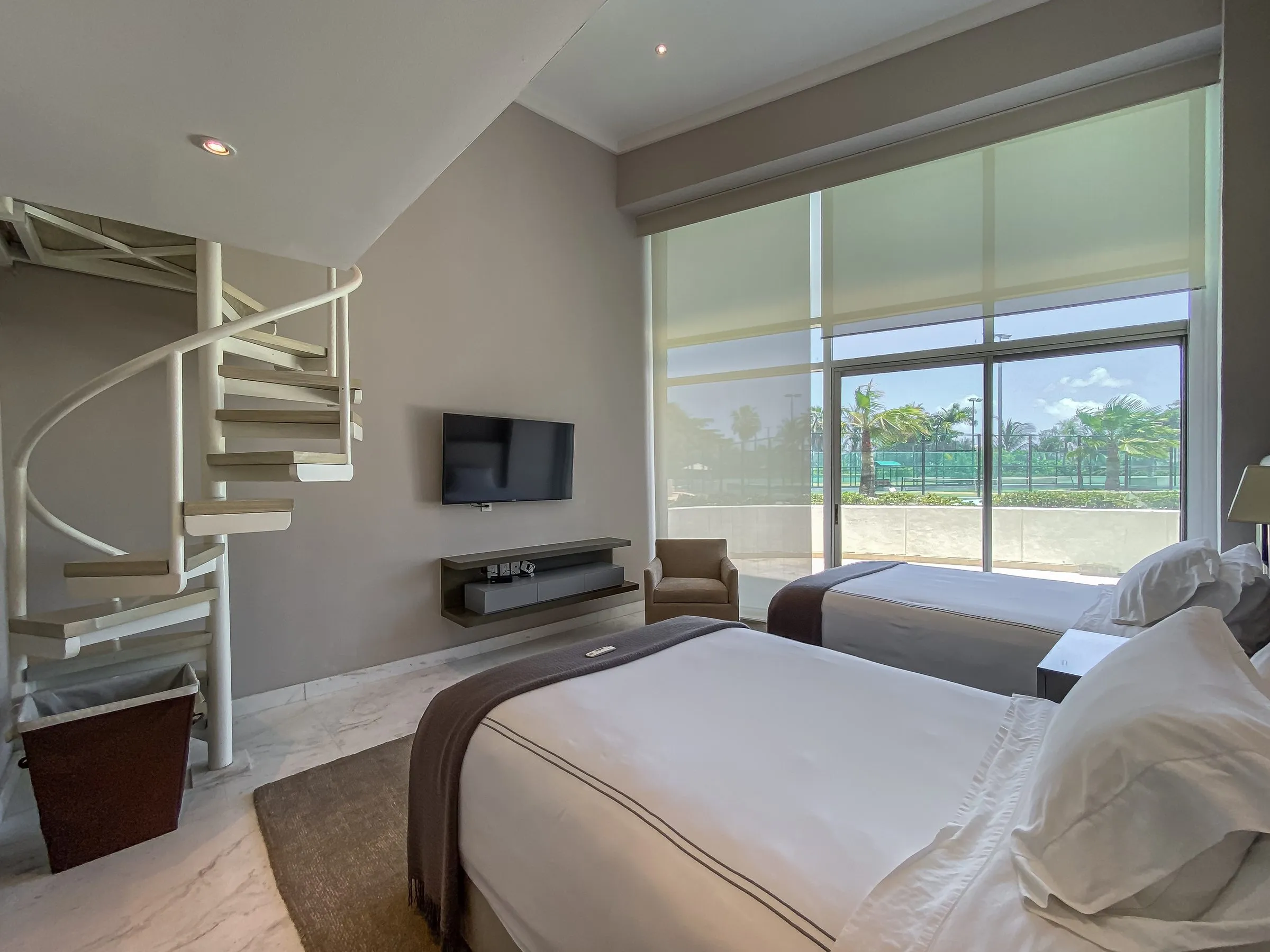 Vacation rental bedroom with bed made and surfaces clear, staged and ready for a shoot