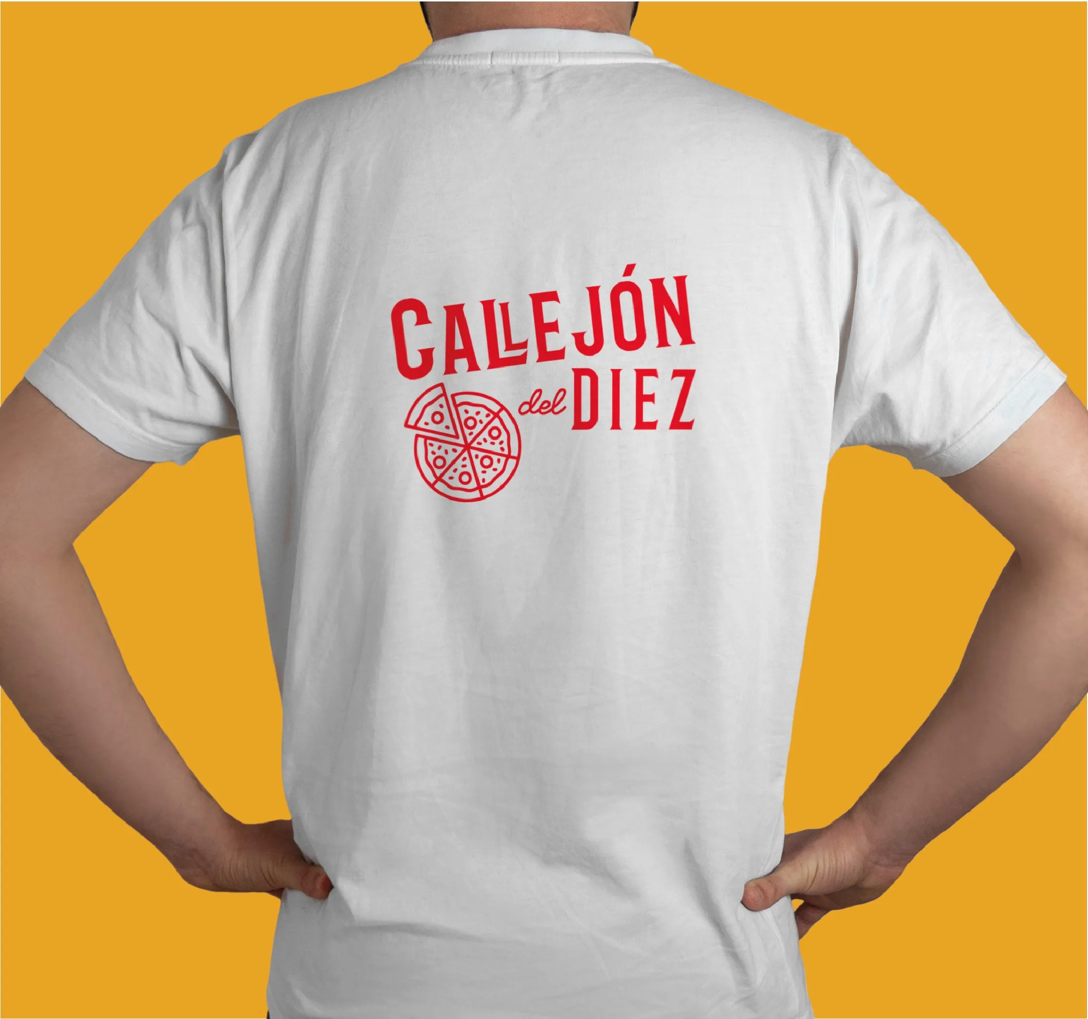 Back of a white t-shirt printed with the Callejón del Diez logo in red, photographed against a yellow background